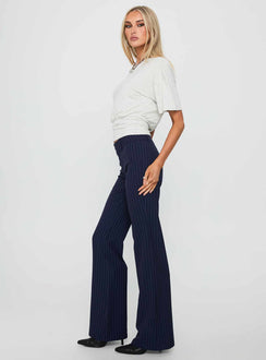 side view of model wearing Princess Polly Kinkirk Flared Pants Navy Pinstripe Low Rise Pants 