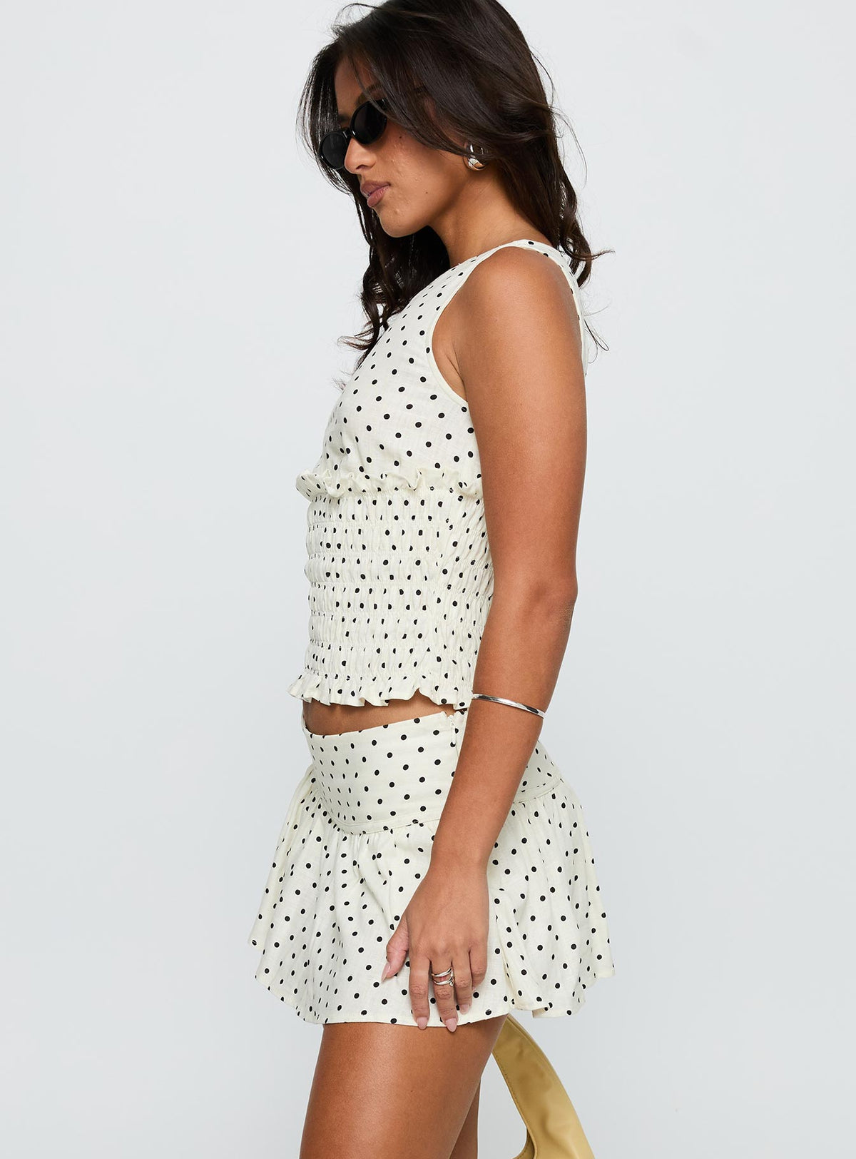 side view of model wearing Princess Polly Tovie Frill Linen Blend Skort Cream Polka Low Rise Shorts 