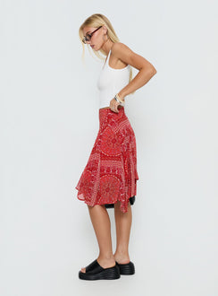   side view of model wearing Princess Polly Raenah Asymmetrical Midi Skirt Red Paisley 