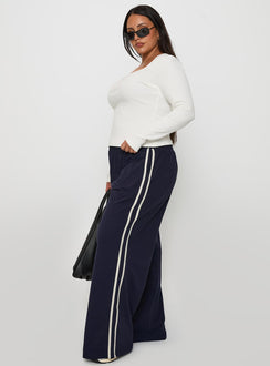 side view of model wearing Princess Polly Circuit Track Pants Navy Curve Pants 
