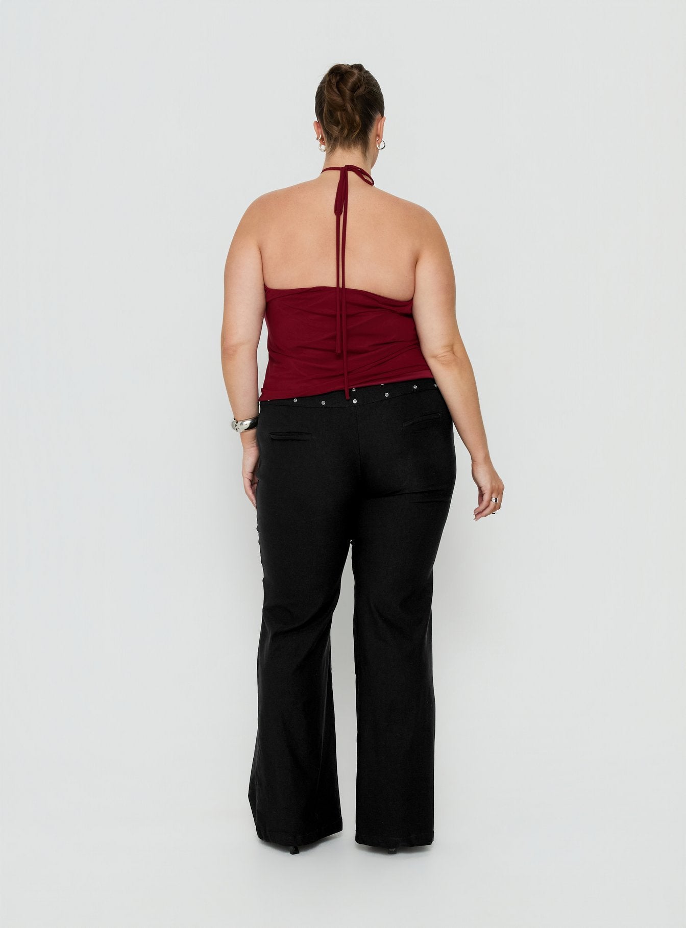 Explore the Yevina Eyelet Flare Pant Black Curve womens-regular-pants in mid-rise back view of model wearing Princess Polly