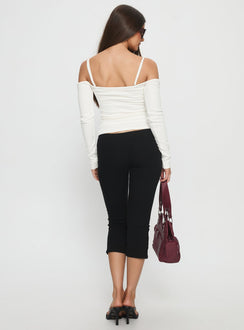 back view of model wearing Princess Polly Baseline Rib Capri Pants Black Petite Mid Rise Pants 