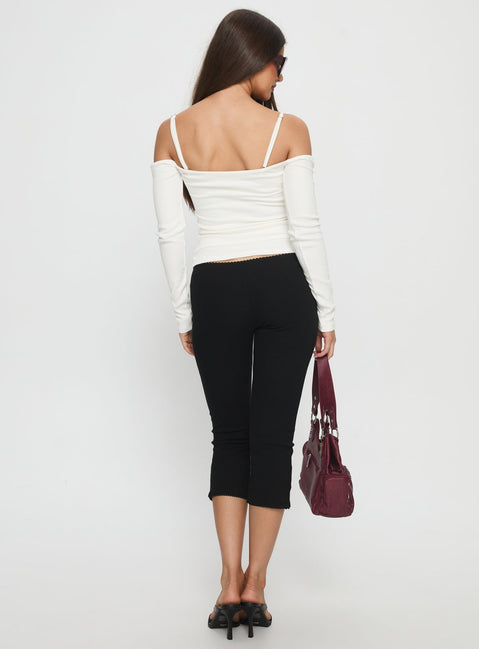 back view of model wearing Princess Polly Baseline Rib Capri Pants Black Petite Mid Rise Pants 