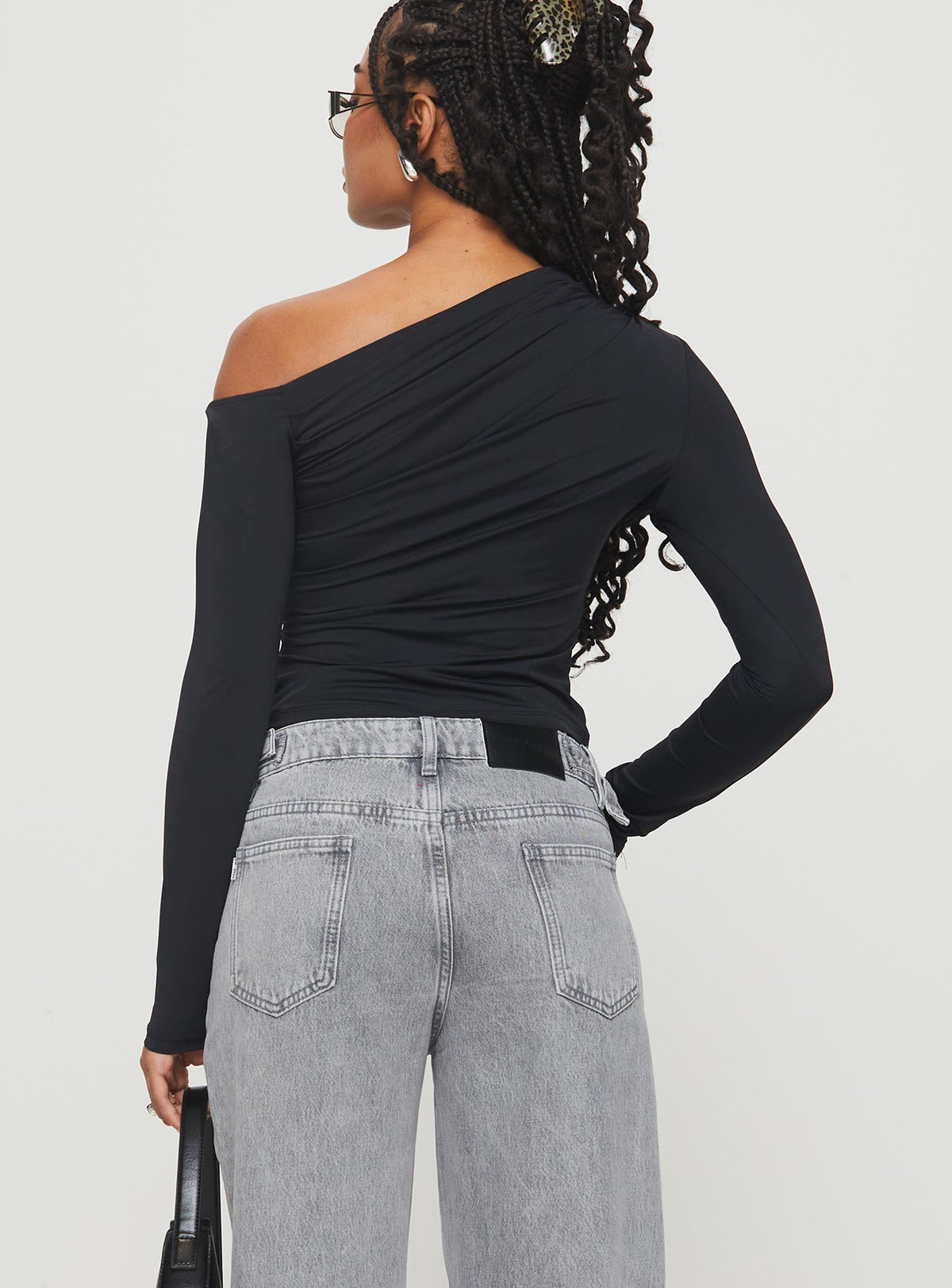 back view of model wearing Princess Polly Lasharie Long Sleeve Top Black Full Sleeves Asymmetric Neckline 