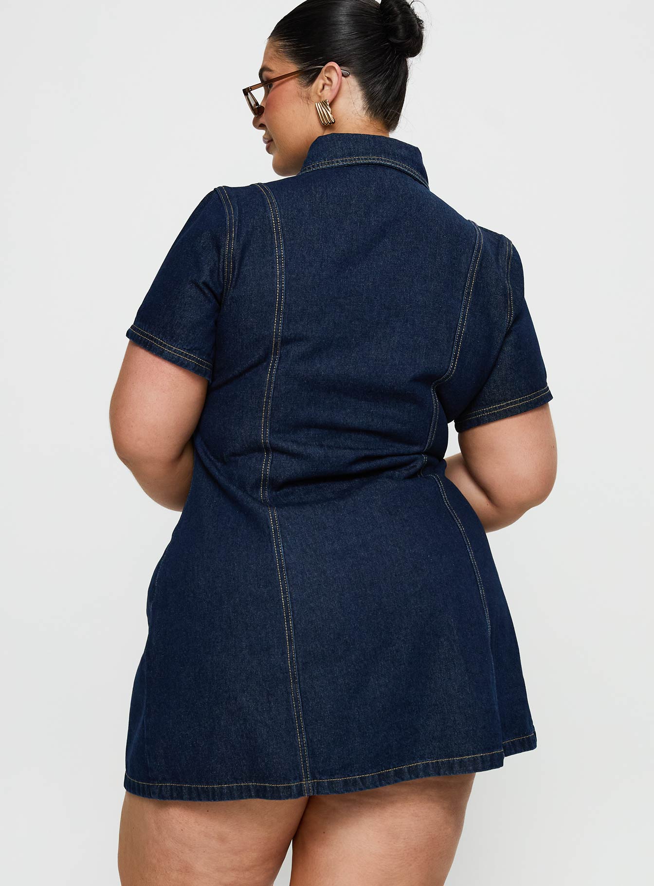 back view of model wearing Princess Polly Perception Denim Mini Dress Mid Wash Curve V-Neck 