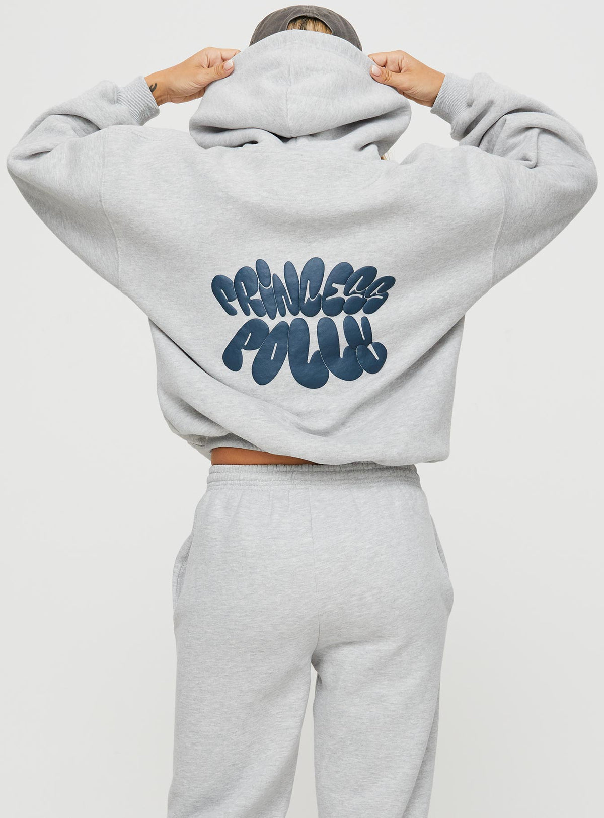 back view of model wearing Princess Polly Princess Polly Hooded Sweatshirt Bubble Text Grey Marle / Slate Jumpers 