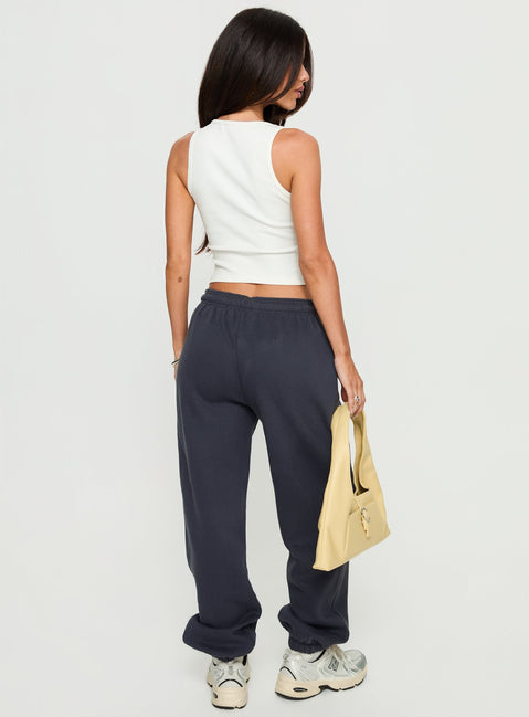 back view of model wearing Princess Polly Caspa Dream Fleece Oversized Ankle Cuff Jogger Navy High Rise Pants 
