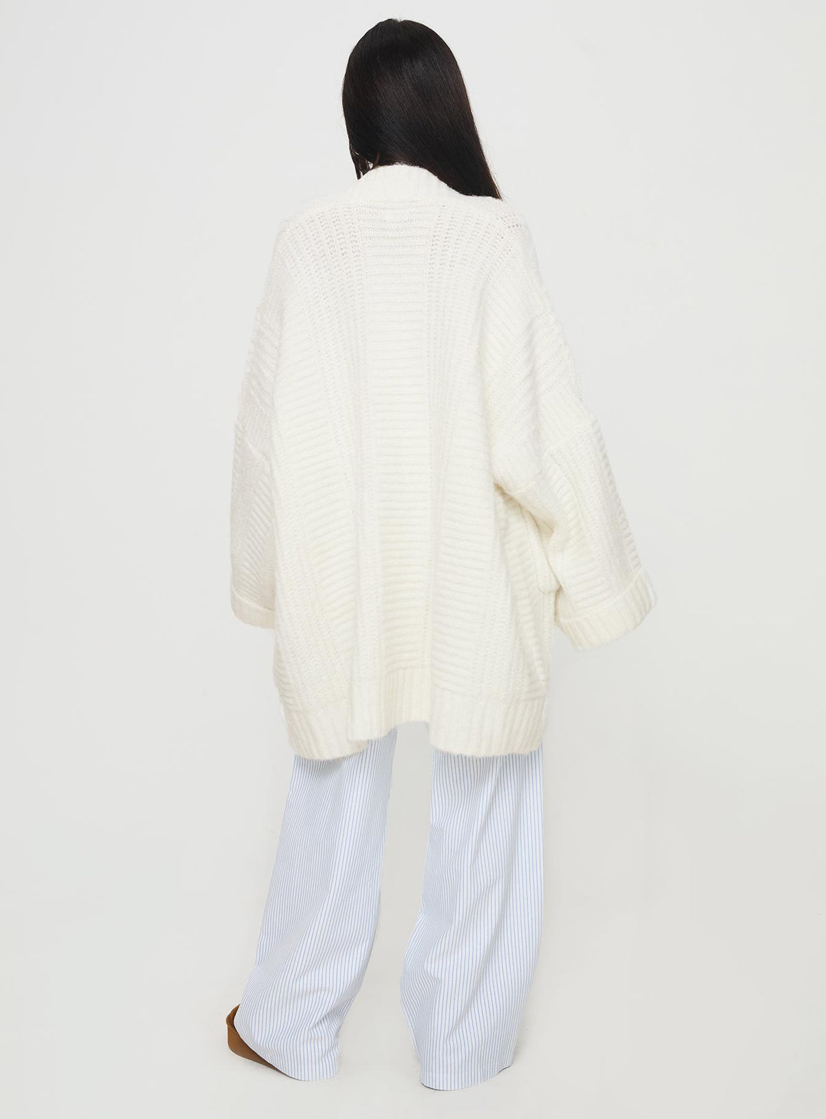 back view of model wearing Princess Polly Paisleigh Cable Knit Cardigan Cream Longline Jumpers Jumpers 