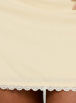 Capturing the Noria Lace Trim Mini Skirt Yellow womens-skirts in a fitted a-line silhouette with solid pattern lace hem detail product