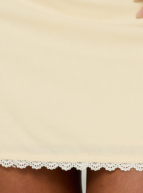 Capturing the Noria Lace Trim Mini Skirt Yellow womens-skirts in a fitted a-line silhouette with solid pattern lace hem detail product