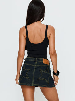 back view of model wearing Princess Polly Electric Star Patch Pocket Mini Skirt Dark Blue Wash Mini Skirts 