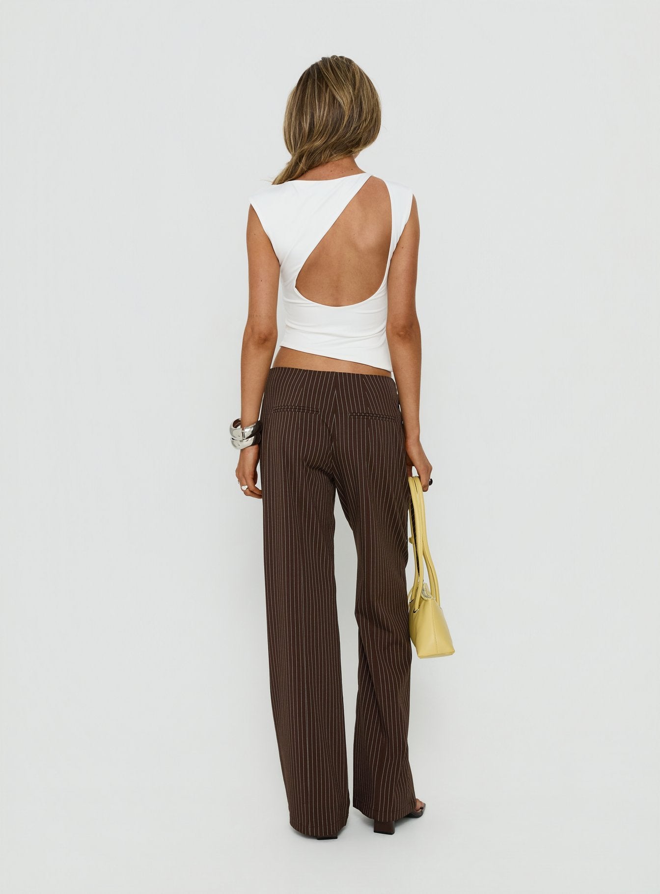 Showcasing sophistication, the Editta Tie Detail Low Rise Tailored Pants Brown Pinstripe in womens-regular-pants with low-rise back view of model wearing