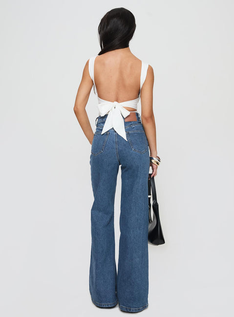 back view of model wearing Princess Polly Lucille High Rise Flare Leg Jeans Mid Wash High Waisted 