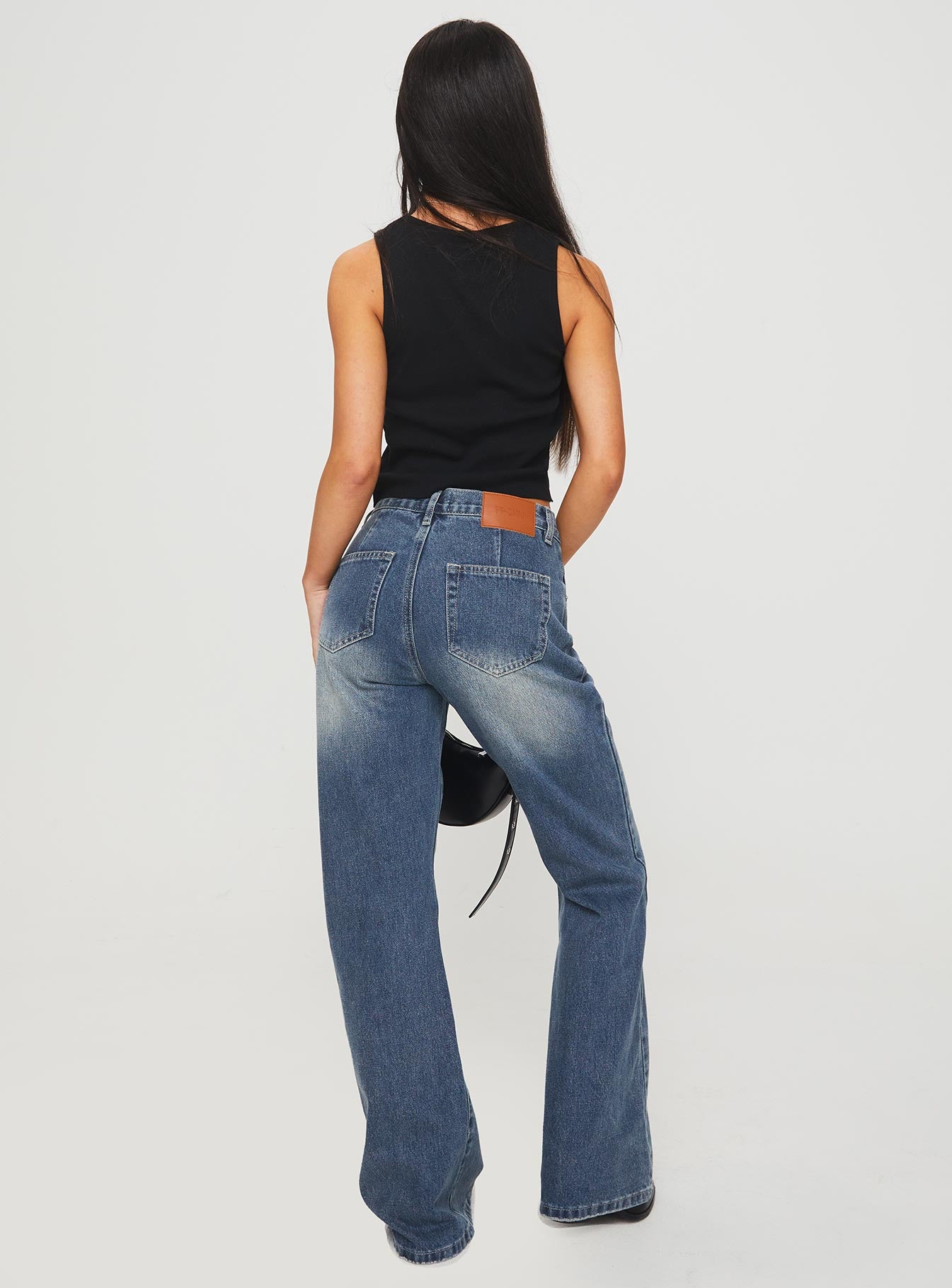 back view of model wearing Princess Polly Hanlen Jean Blue High Waisted 