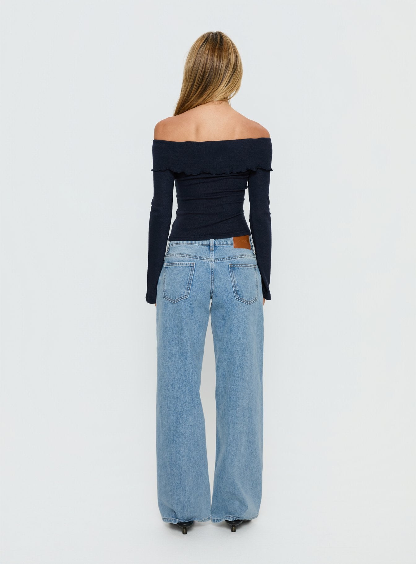 Highlighting Ellanor Low Rise Slouch Denim Jean Washed Mid Blue Wash Petite womens-jeans back view of model wearing Princess Polly