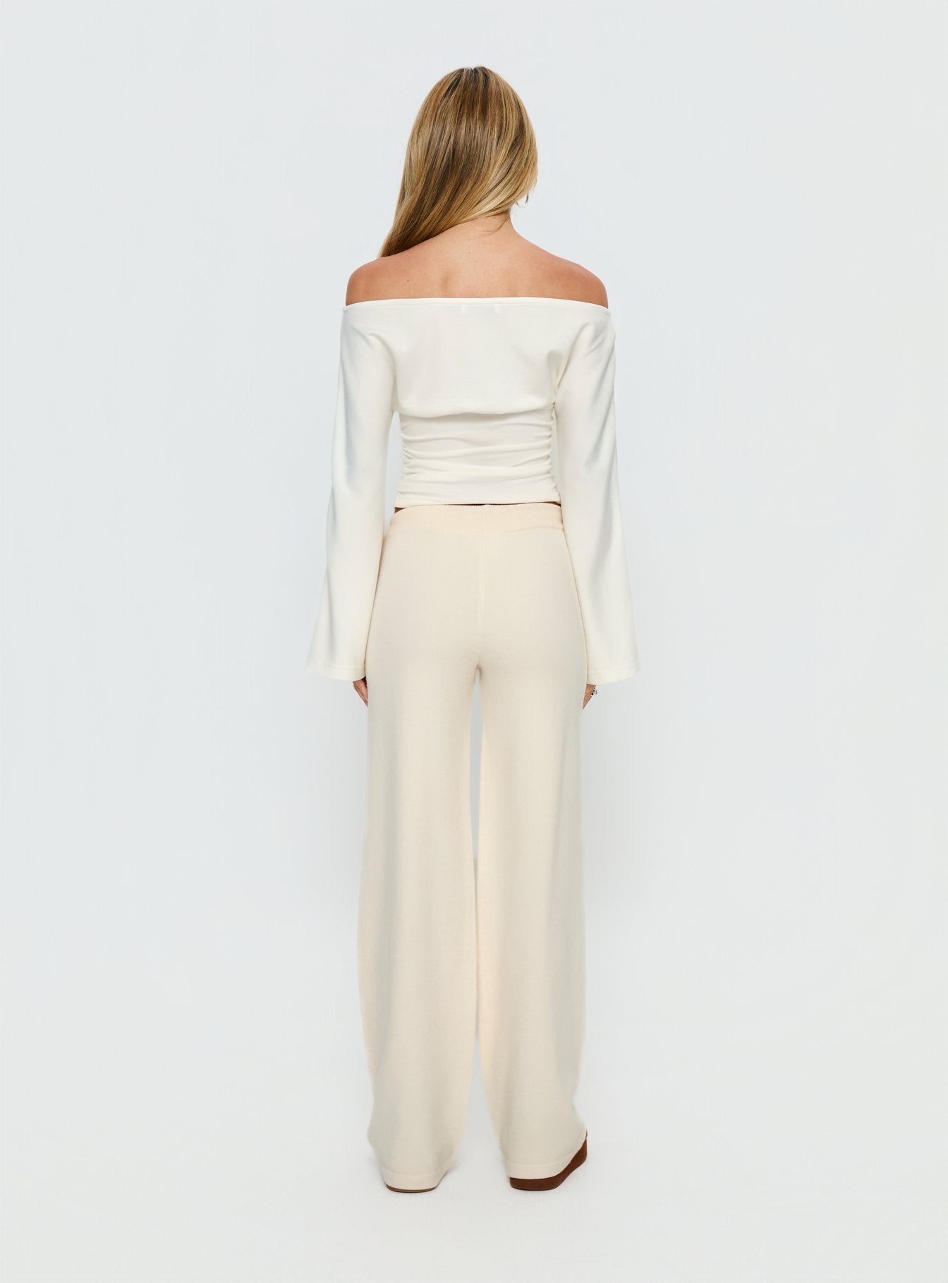 back view of model wearing Princess Polly Felisha Low Waist Knit Pants White Mid Rise Pants 