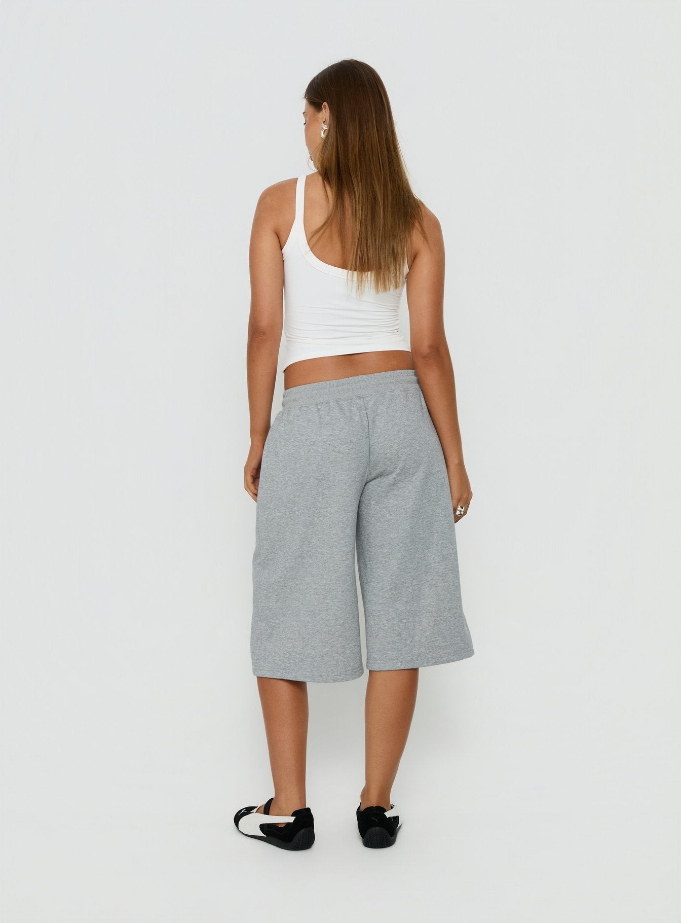 Designed for comfort, the Nikko Longline Fleece Shorts Grey Marle in womens regular pants with mid-rise back view of model wearing Princess Polly