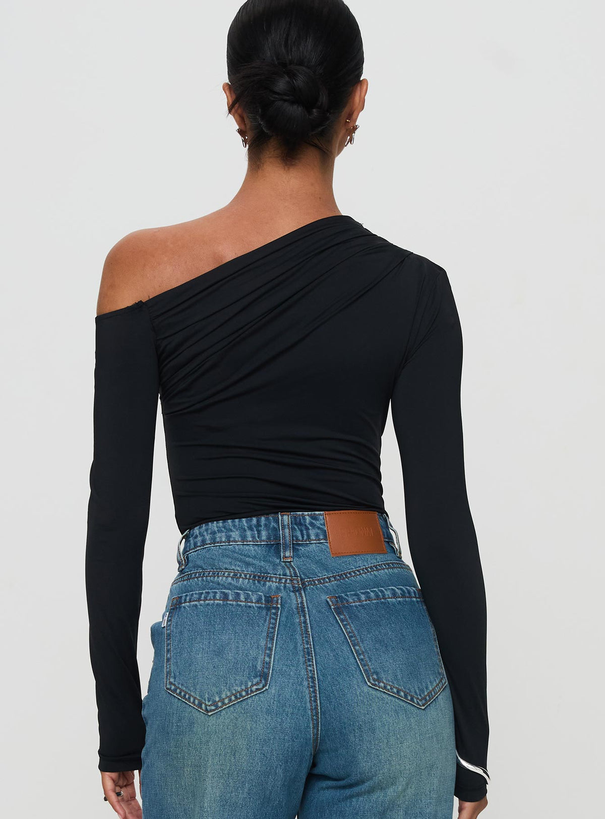 back view of model wearing Princess Polly Antilles One Shoulder Bodysuit Black Full Sleeves 