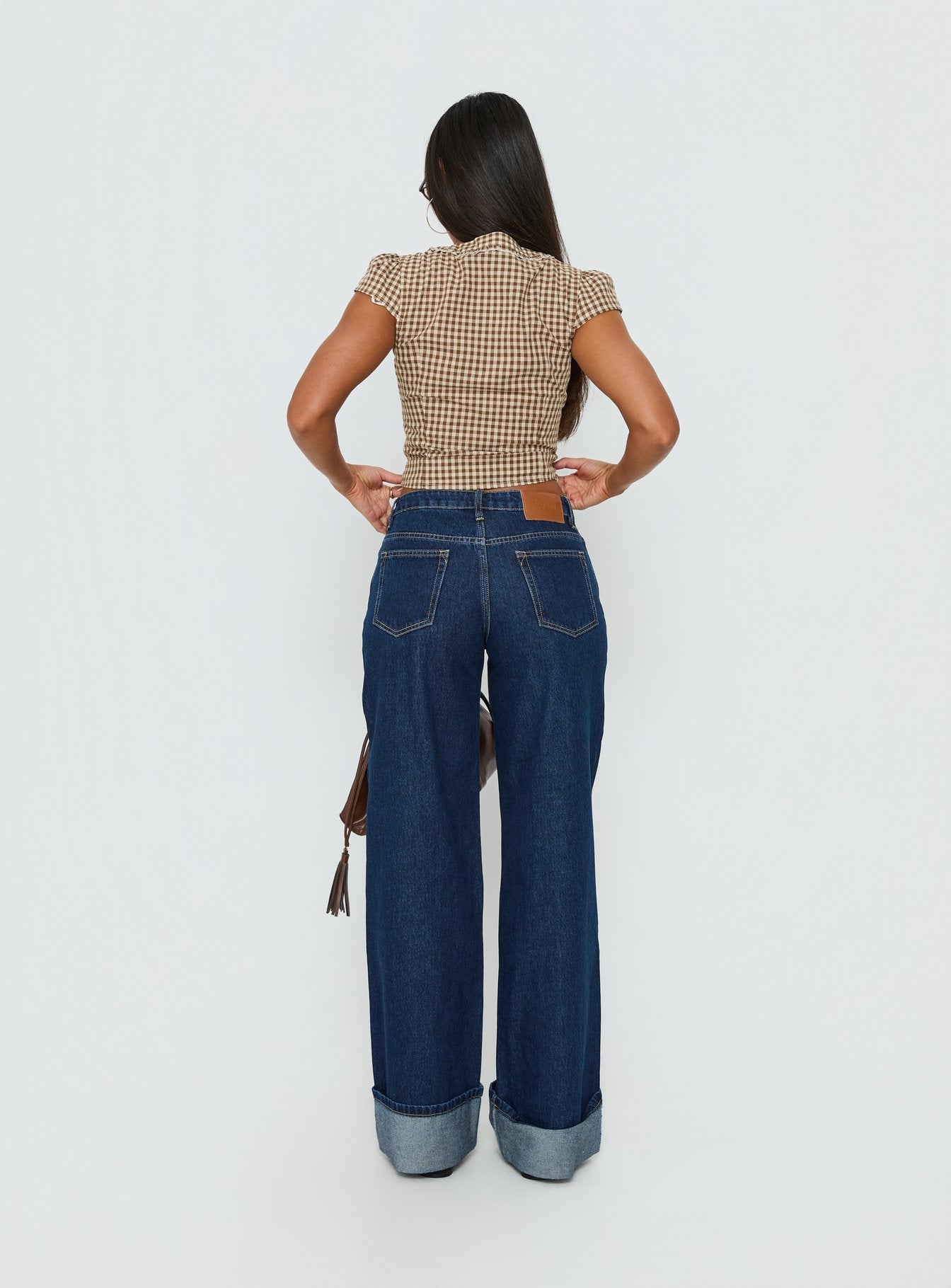 back view of model wearing Princess Polly Darla Low Rise Straight Leg Cuff Jean Dark Blue Wash Low Rise Jeans 