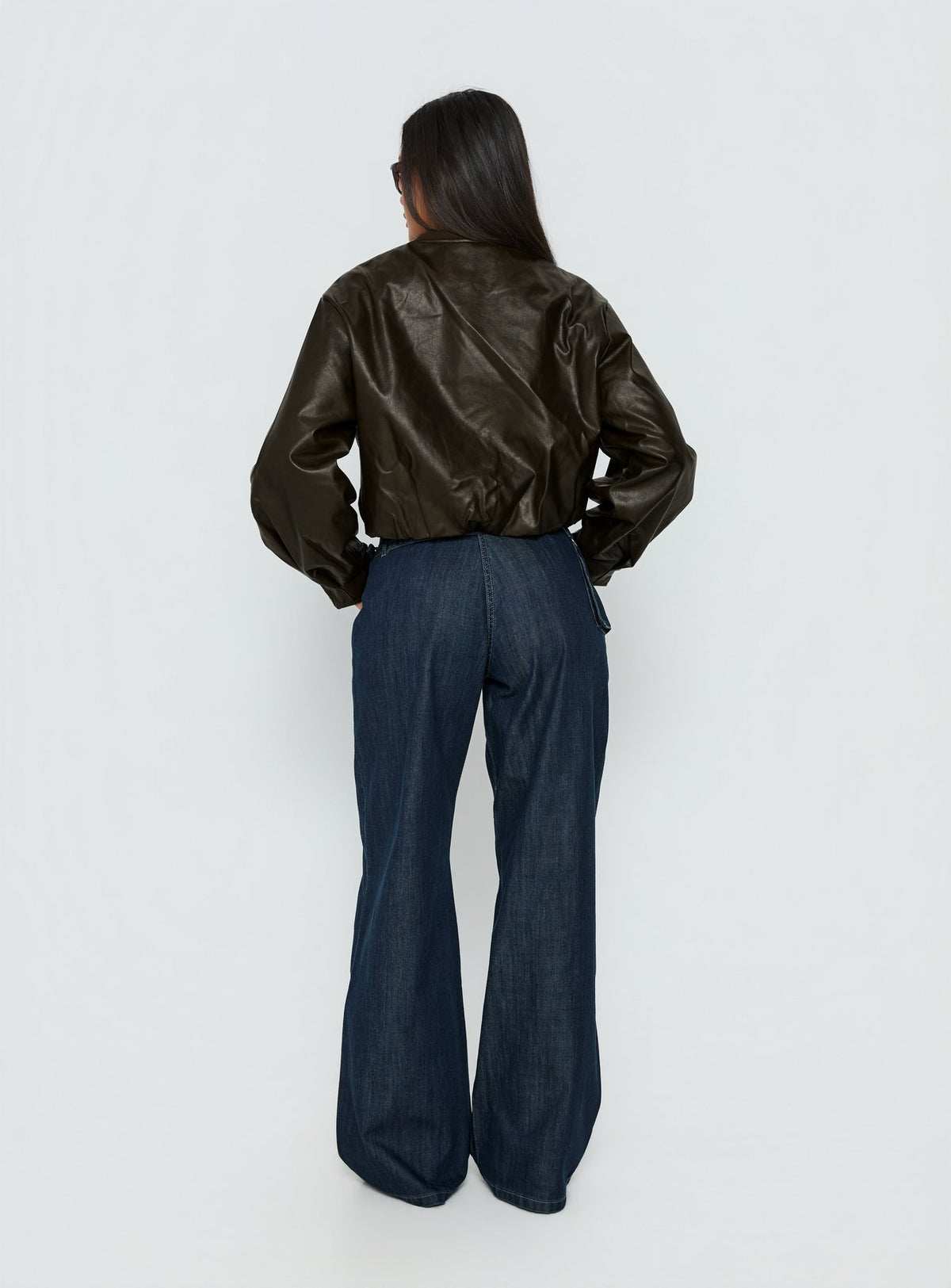 back view of model wearing Princess Polly Paltrow Mid Rise Wide Leg Cargo Jeans Dark Blue Wash Mid Rise Jeans 
