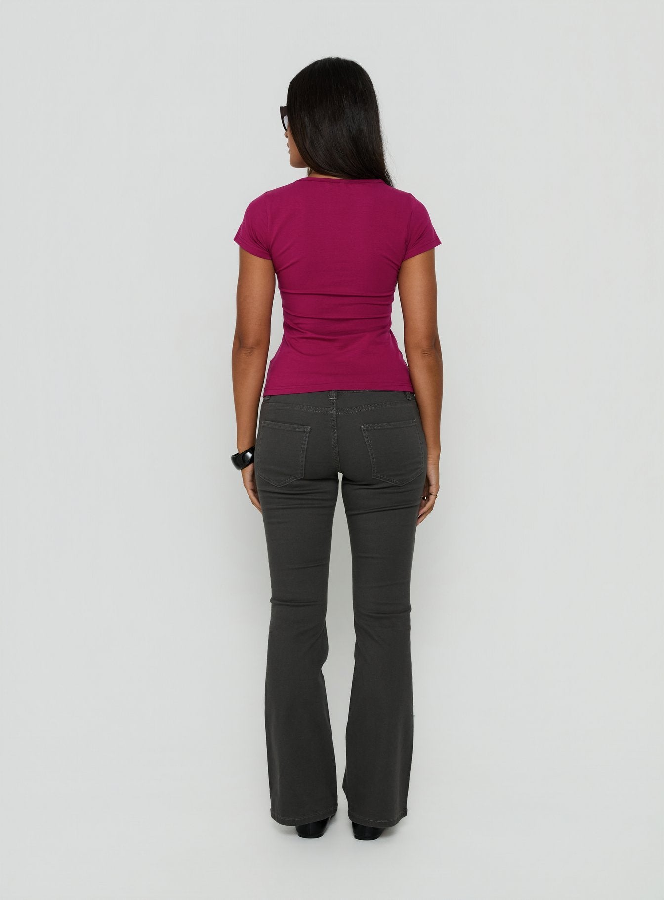Styled in a low rise design, the Trust Fund Bootleg Cargo Pants Charcoal in womens regular pants, back view of model wearing Princess Polly