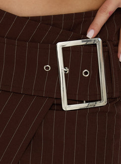 Explore the Myrienne Belted Mini Skirt Brown Pinstripe womens skirts with belt and silver hardware detail Princess Polly