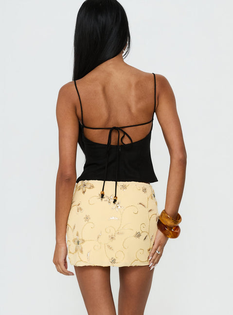 back view of model wearing Princess Polly Calyra Embroidered Mini Skirt Butter Yellow Mini Skirts 