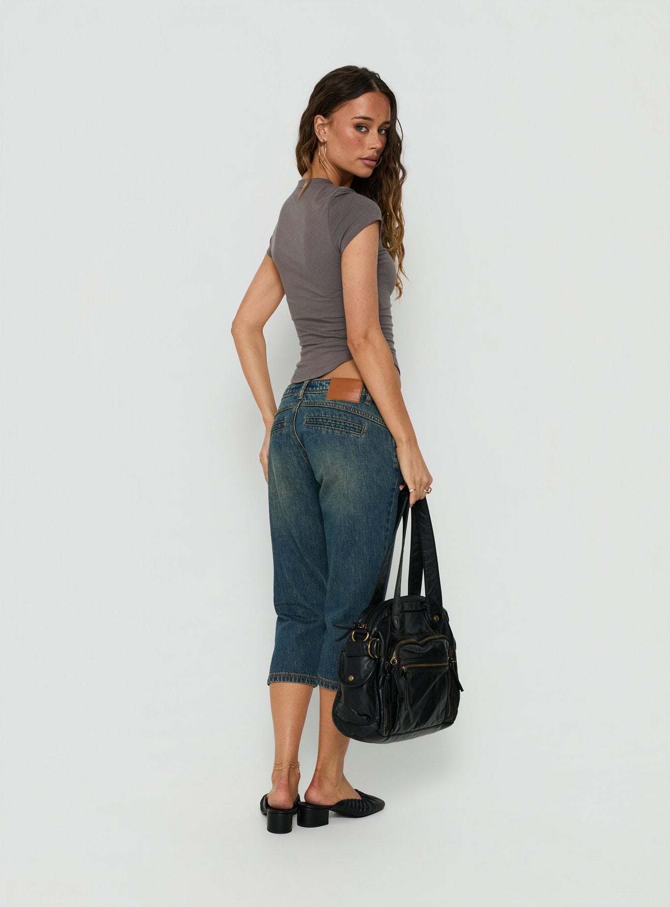 Shop the Ceilea Ultra Low Rise Denim Capri Pants Dirty Blue in womens regular pants with low-rise waist back view of model wearing Princess Polly