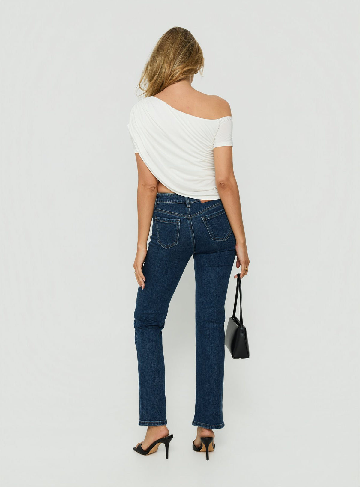 Featuring the Harpor Mid Rise Slim Skinny Jean Mid Blue Wash womens-jeans with belt back view of model wearing Princess Polly