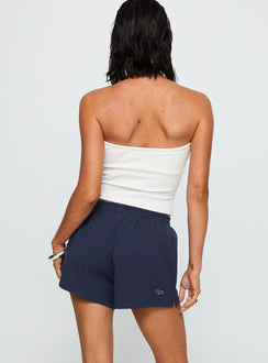 back view of model wearing Princess Polly Columbia Soffee Shorts Navy 