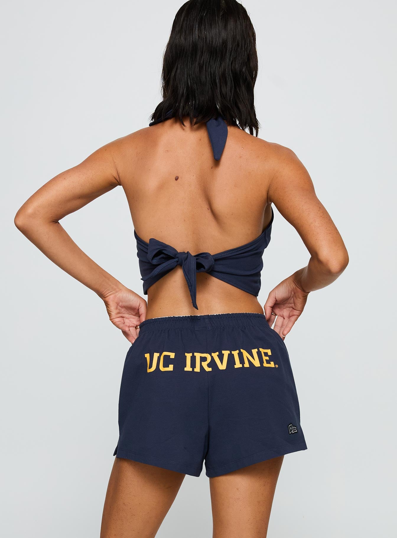 back view of model wearing Princess Polly UC Irvine Soffee Shorts Blue High Waisted Shorts 
