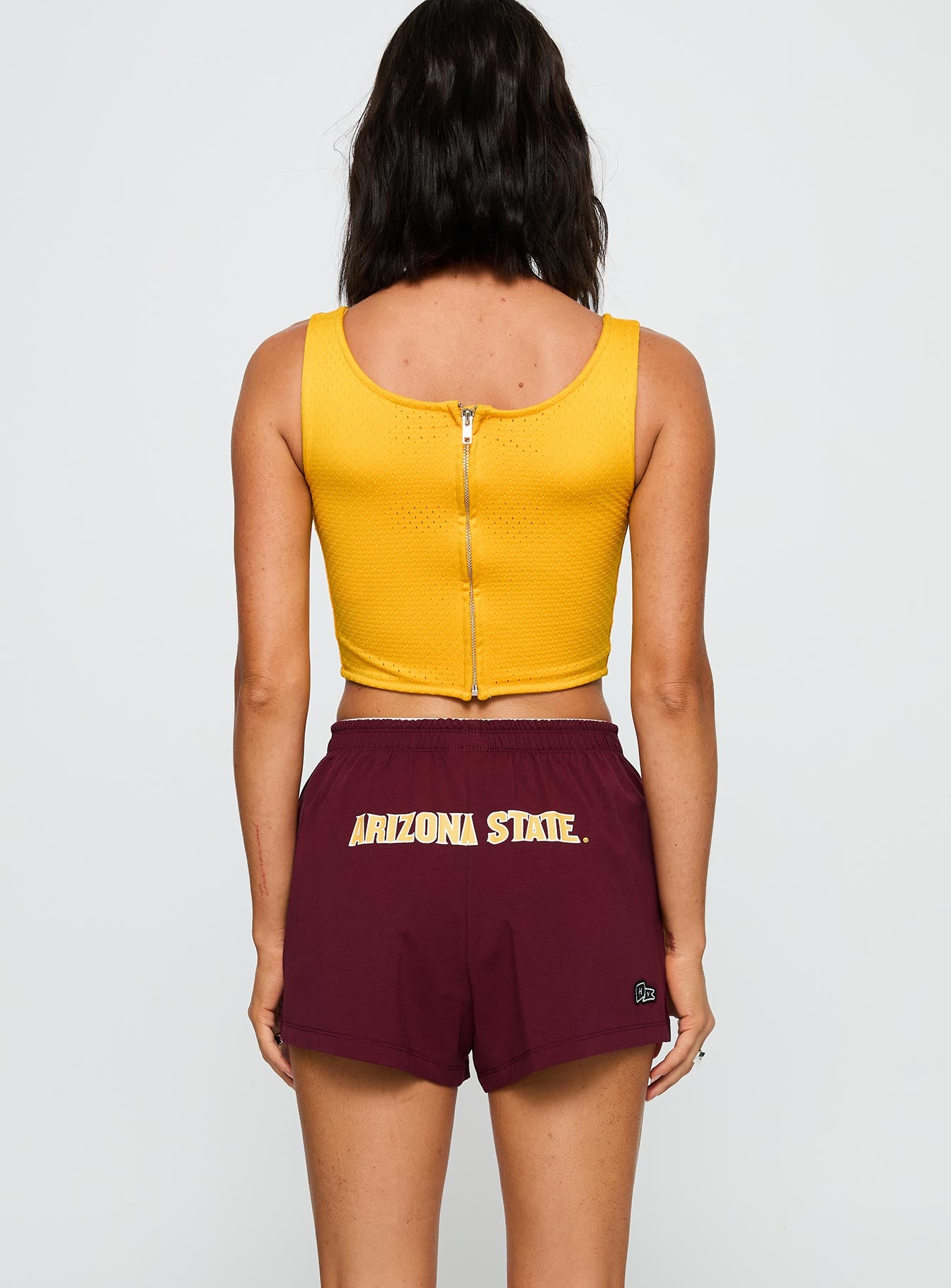 back view of model wearing Princess Polly ASU Jersey Corset Top Gold Sleeveless Square Neck 