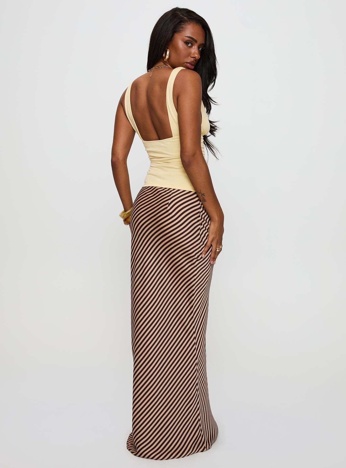 Designed with elegance, the Eliena Maxi Skirt Multi Tall womens-skirts in maxi length back view of model wearing
