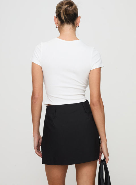 back view of model wearing Princess Polly Grant My Wish Mini Skort Black High Waisted Shorts 