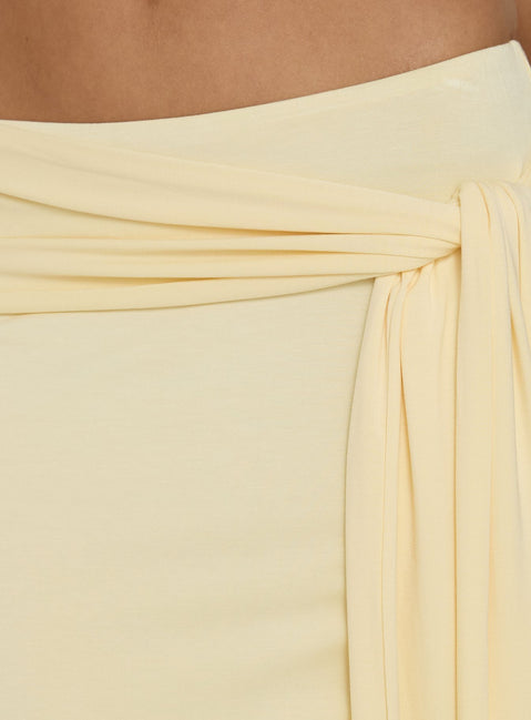 Close-up of the Aymee Tie Detail Maxi Skirt in Yellow, a women's skirt with relaxed fit, lace hem, solid print, aline shape, and wrap details Princess Polly