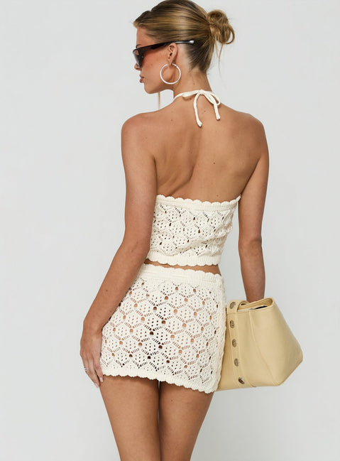 Designed with delicate crochet detailing, the Harrietah Tie Waist Mini Skirt in white showcases a fitted aline shape and mini length back view of model wearing Princess Polly