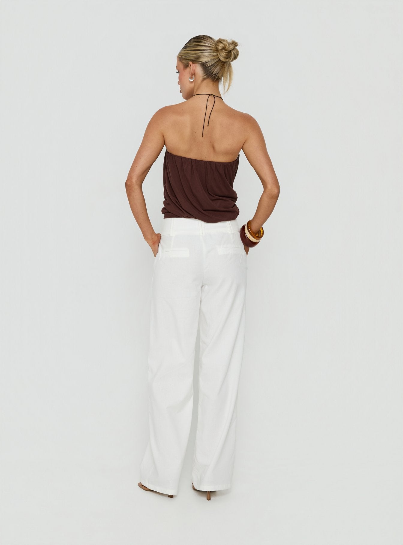 Designed with the Two Lovers Linen Low Rise Pants White in womens regular pants, showcasing wide-leg silhouette and low-rise fit, back view of model wearing