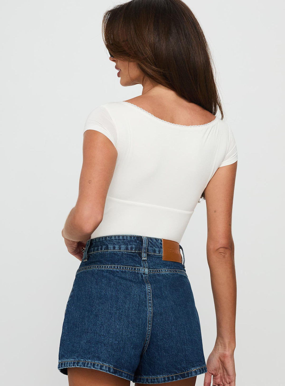 back view of model wearing Princess Polly Loveydove Short Sleeve Bodysuit White Short Sleeve Bodysuit 
