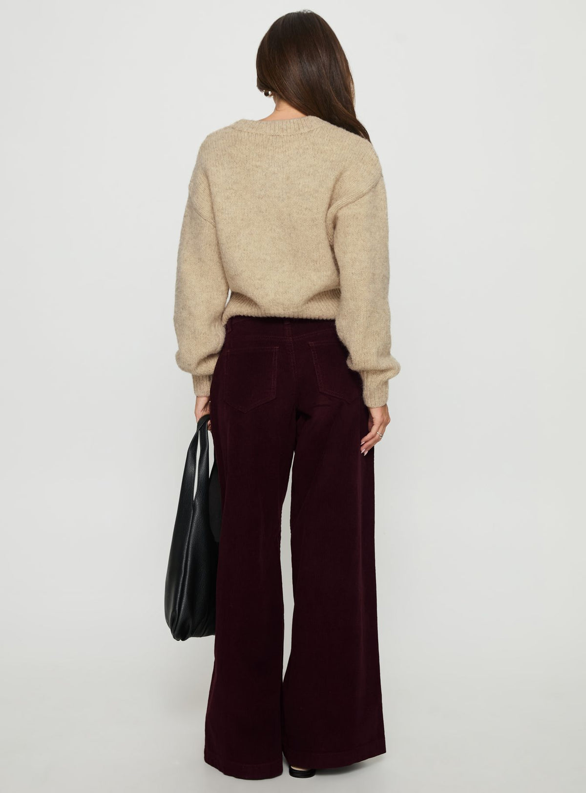 back view of model wearing Princess Polly Jacynda Low Waist Wide Leg Corduroy Jeans Currant Mid Rise Jeans 