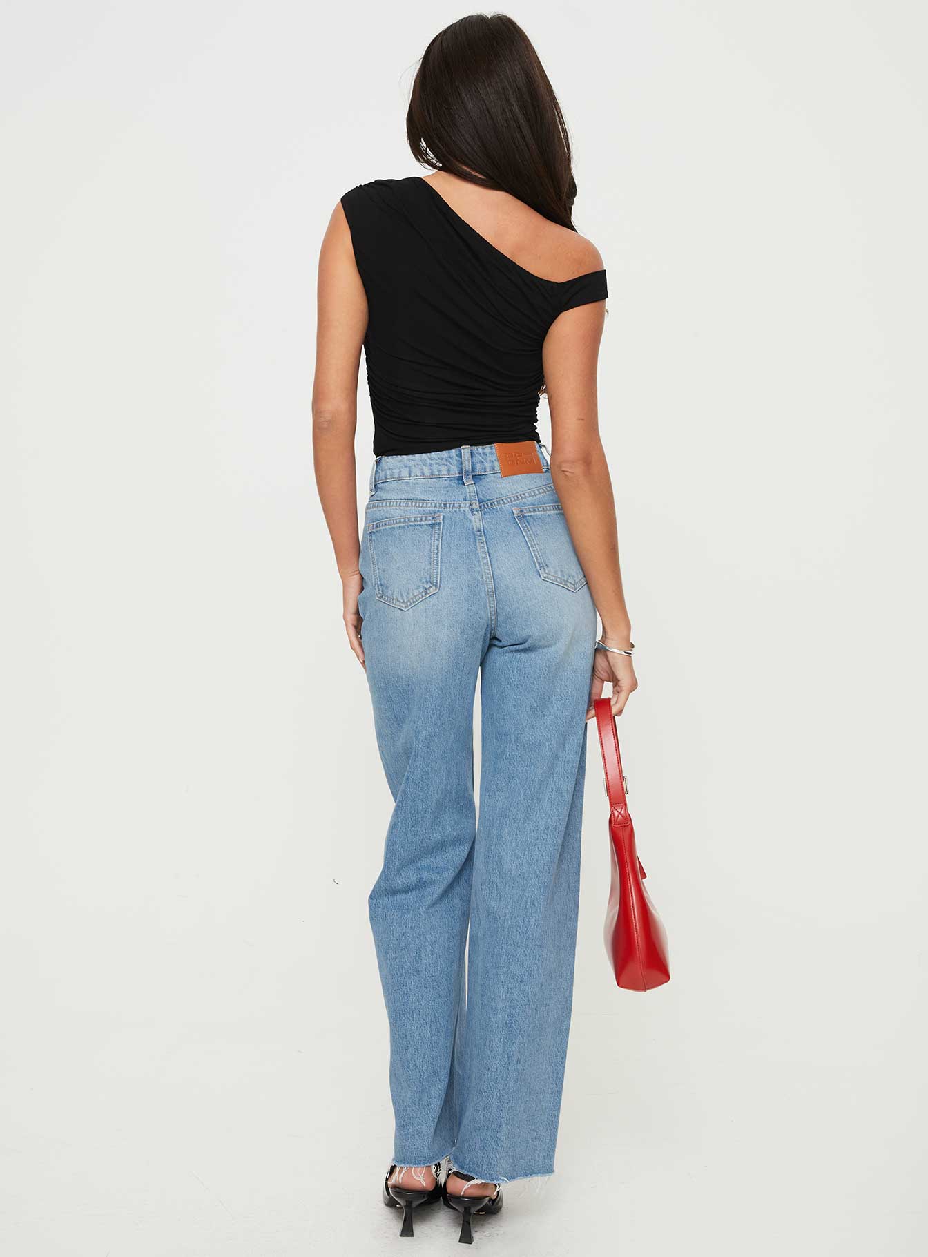 back view of model wearing Princess Polly Henesey Raw Hem Jeans Mid Wash Tall High Waisted 
