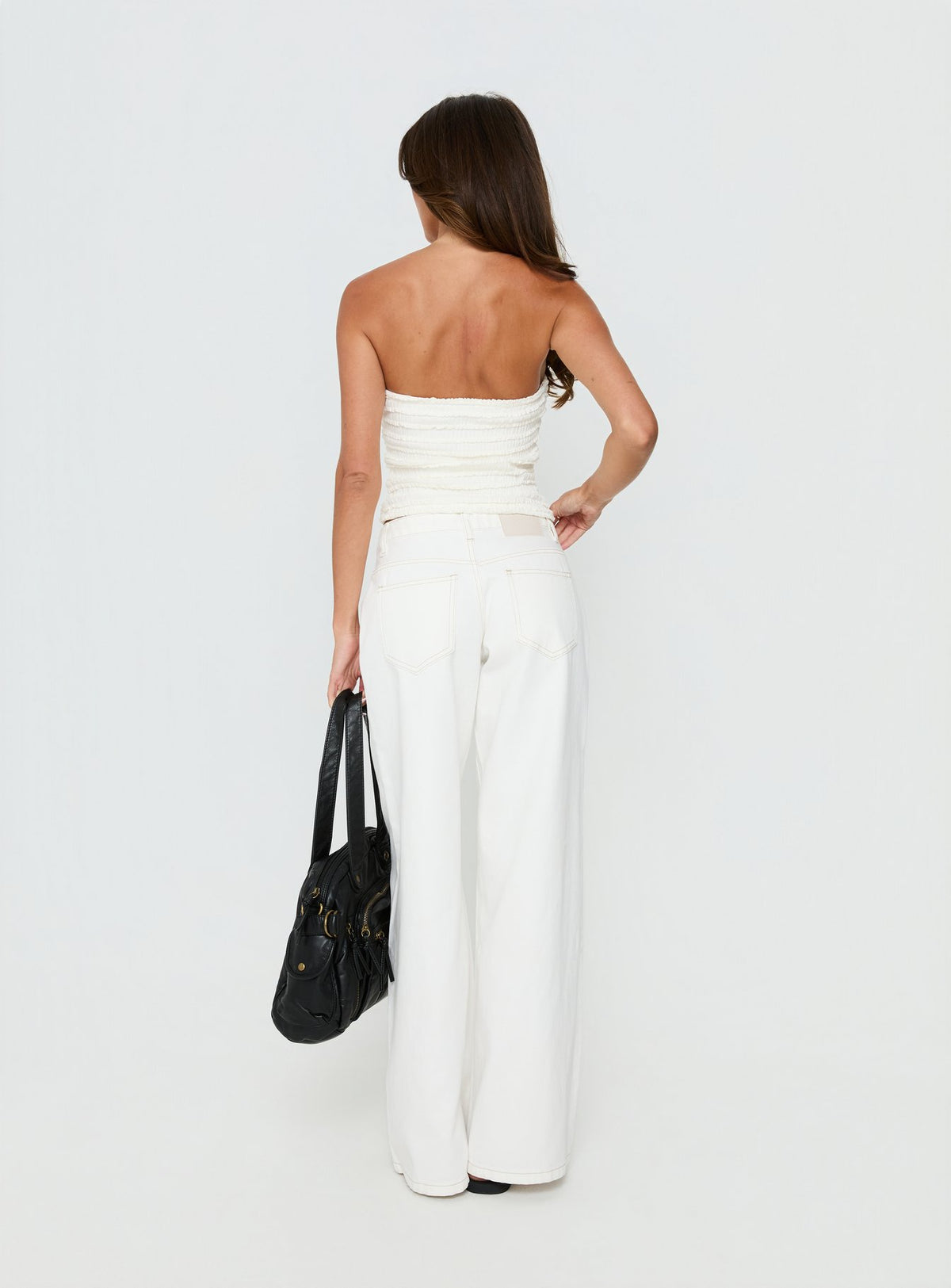 back view of model wearing Princess Polly Supercut Low Rise Baggy Pleat Jeans Cream Mid Rise Jeans Jeans 