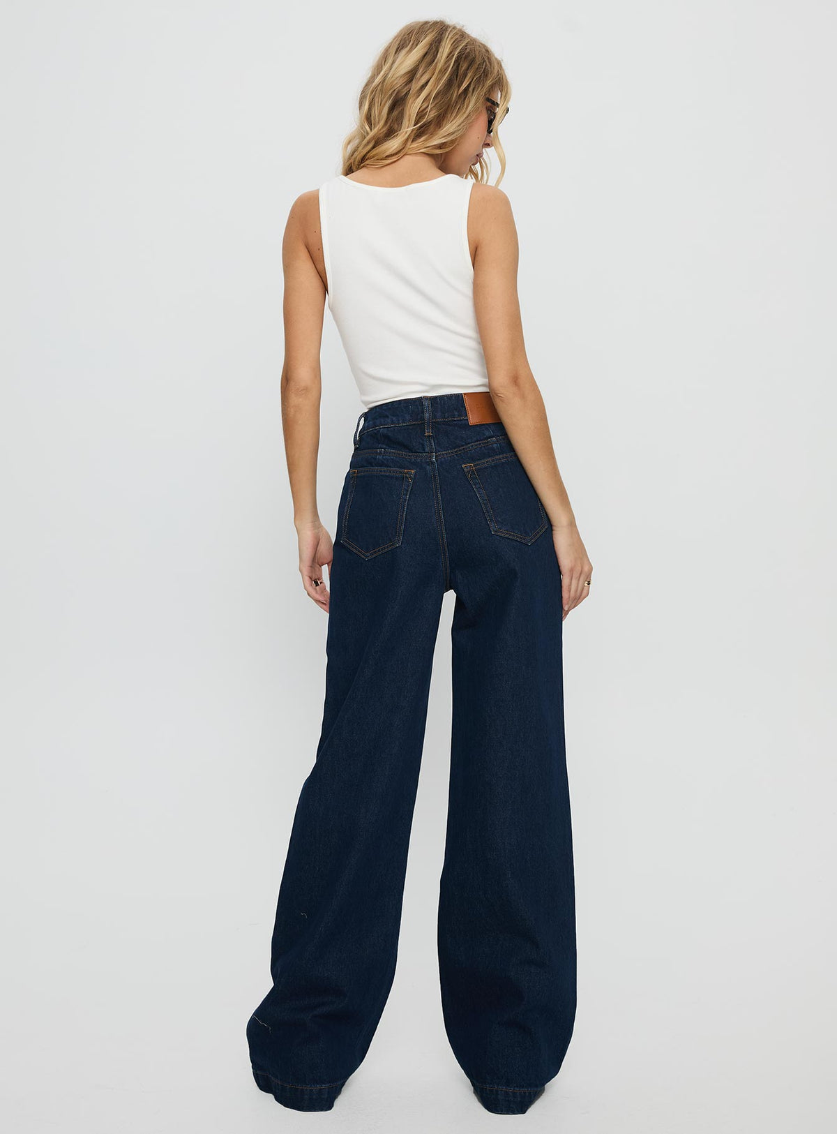 back view of model wearing Princess Polly Goldie High Rise Wide Leg Jeans Indigo High Rise Jeans 