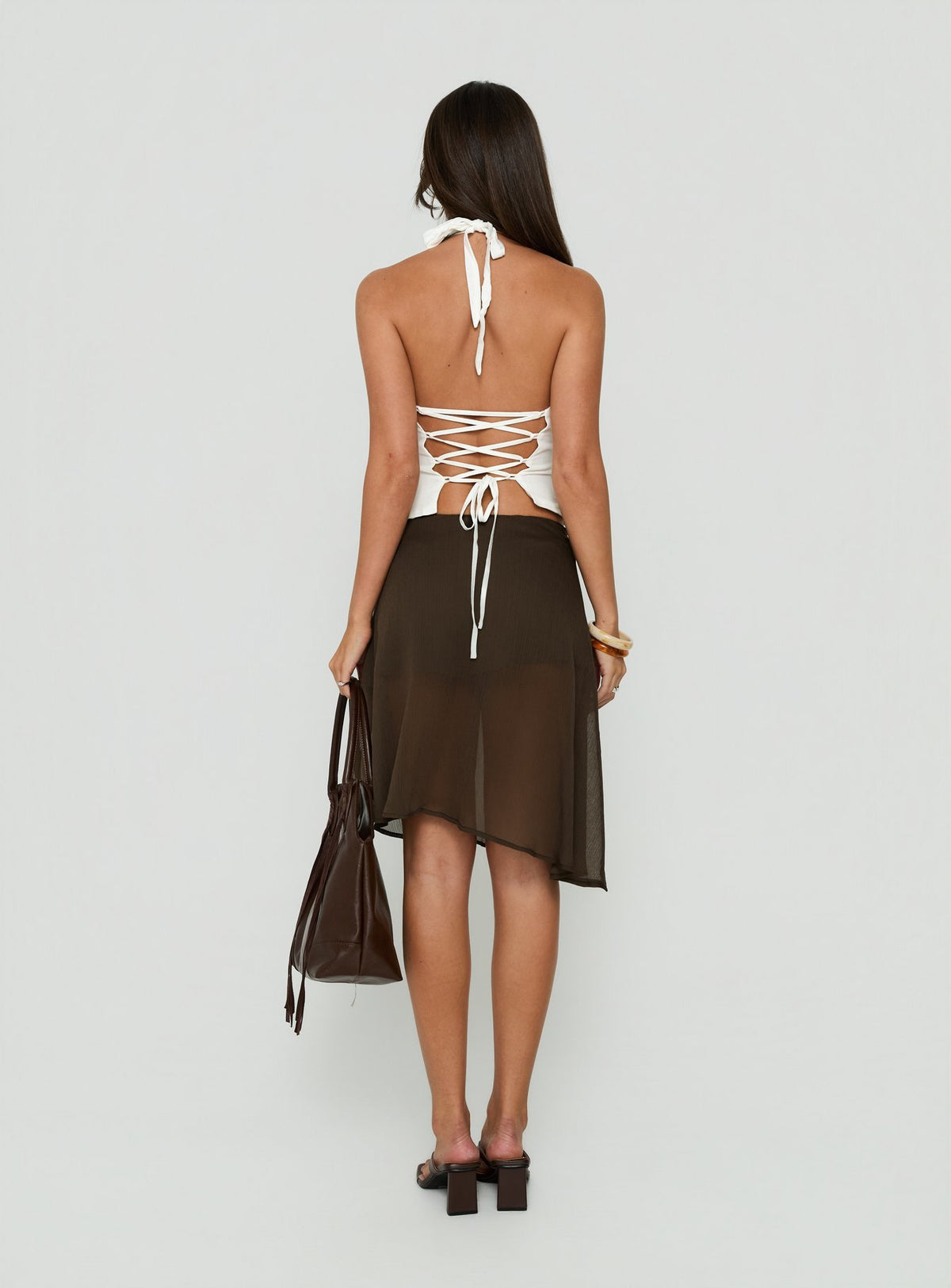 Explore the Eliodora Layered Sheer Midi Skirt Brown in womens-skirts with midi length back view of model wearing