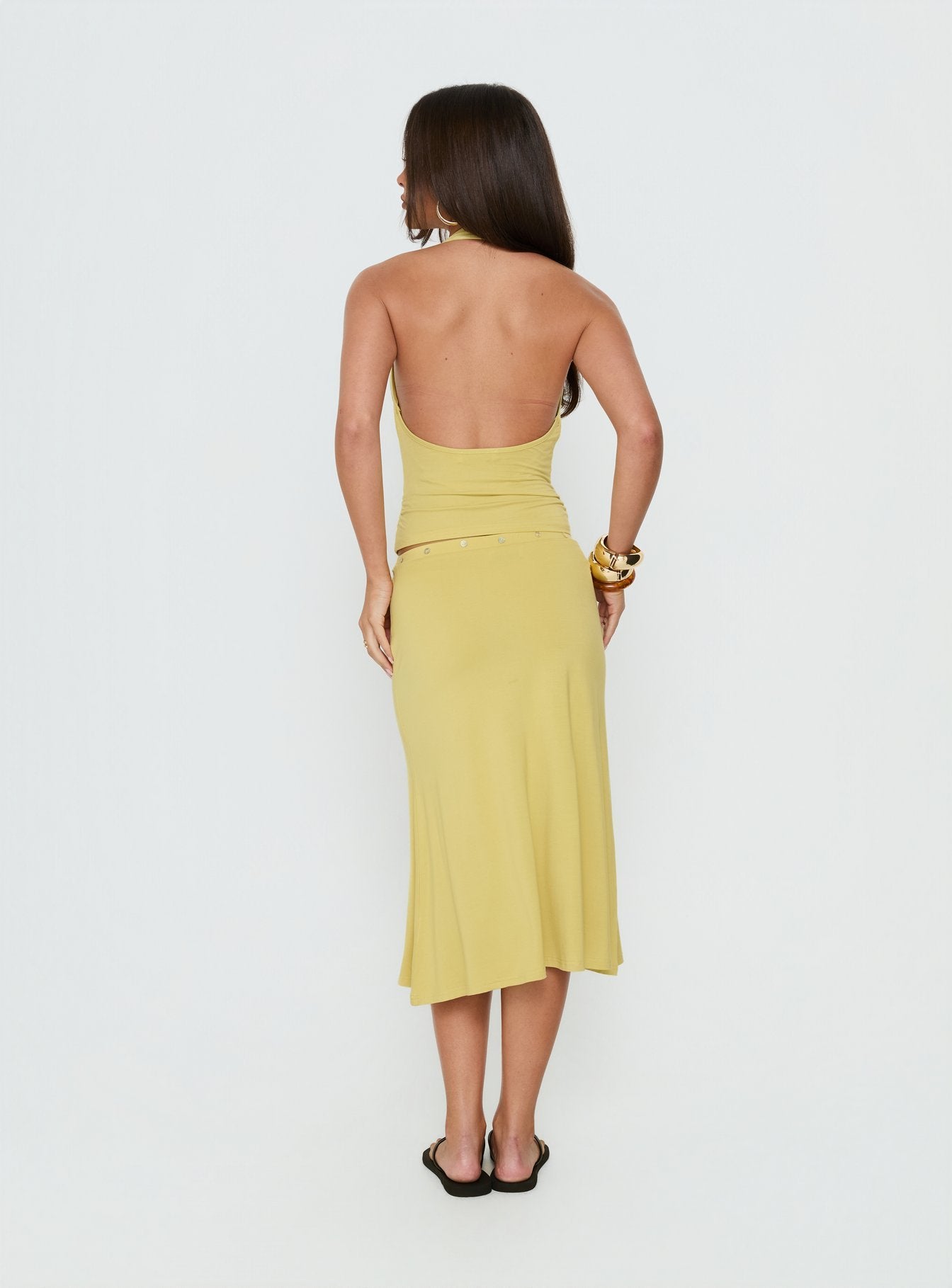 Presenting the Esperia Button Midi Skirt Green in fitted aline womens-skirts back view of model wearing Princess Polly