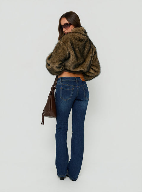 Experience Naketa Ultra Low Rise Bootleg Jeans Mid Blue Wash womens-jeans with low-rise design back view of model wearing Princess Polly