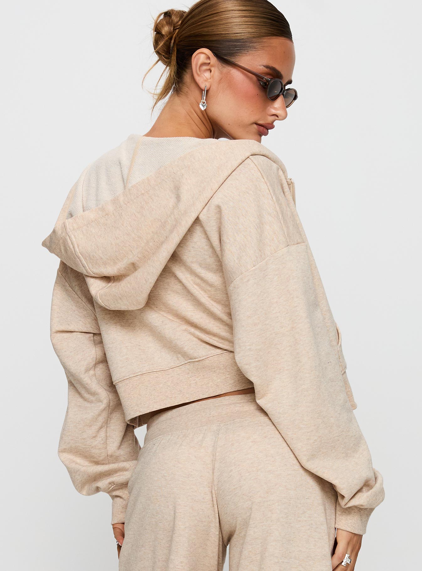 back view of model wearing Princess Polly Revive Zip Through Hoodie Oat Marle cropped Jumpers 