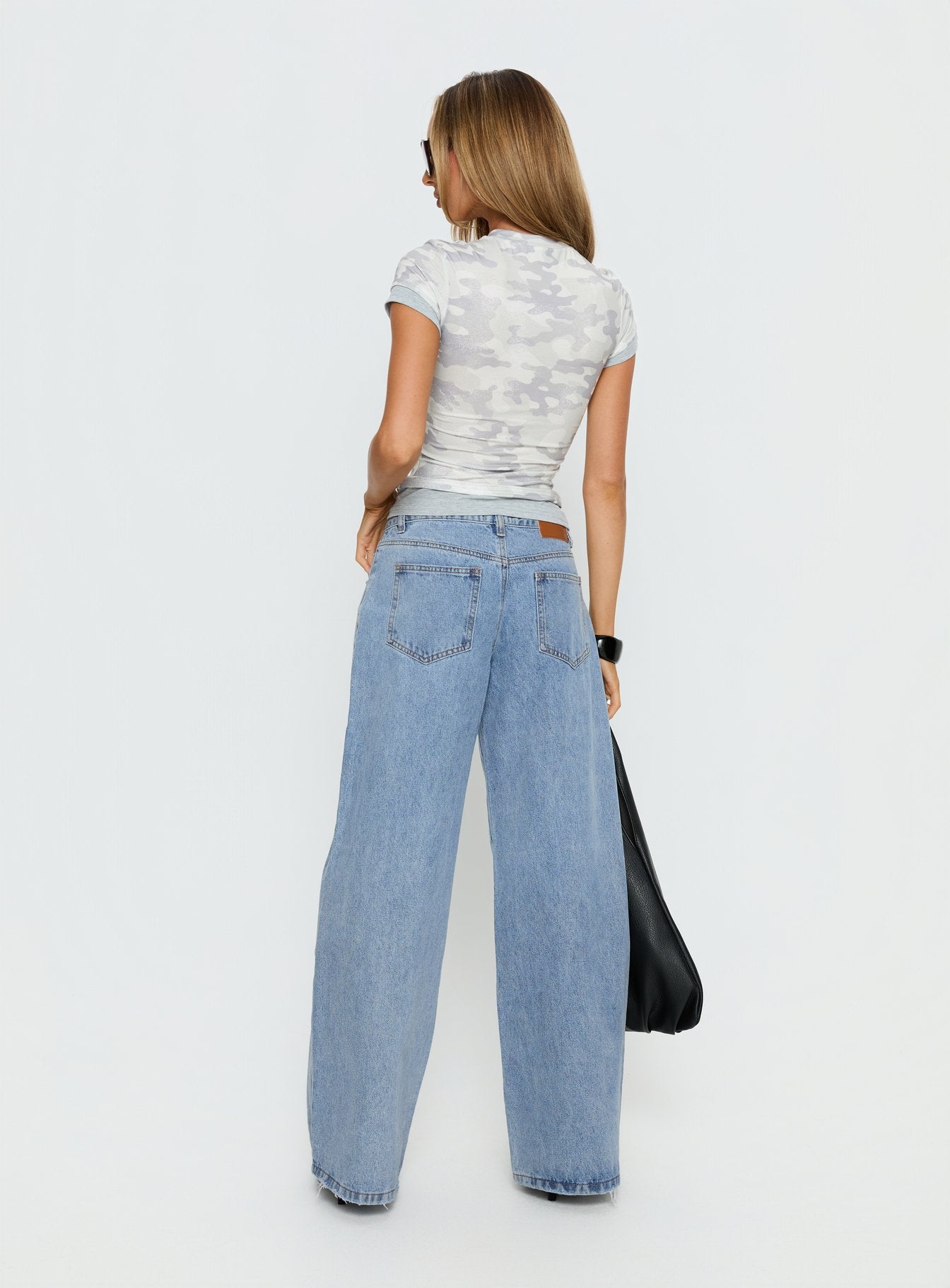 back view of model wearing Princess Polly Candi Mid Rise Wide Leg Studded Jeans Light Blue Wash Mid Rise Jeans 
