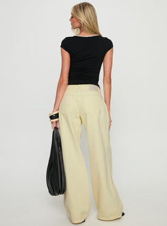 back view of model wearing Princess Polly Ramos Low Rise Wide Leg Jeans Butter Lemon Low Rise Jeans 
