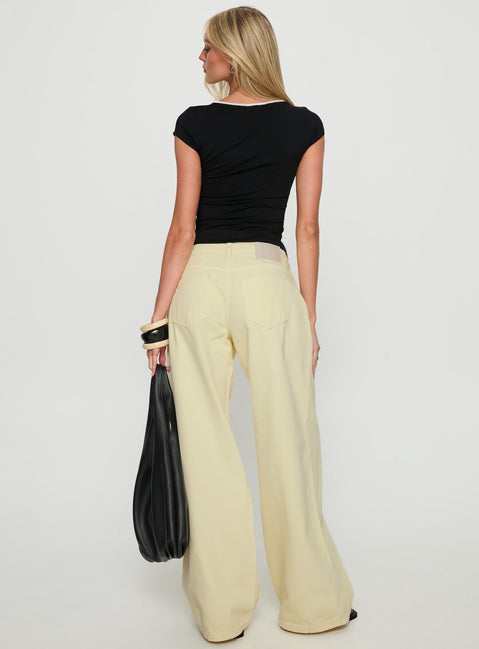back view of model wearing Princess Polly Ramos Low Rise Wide Leg Jeans Butter Lemon Low Rise Jeans 