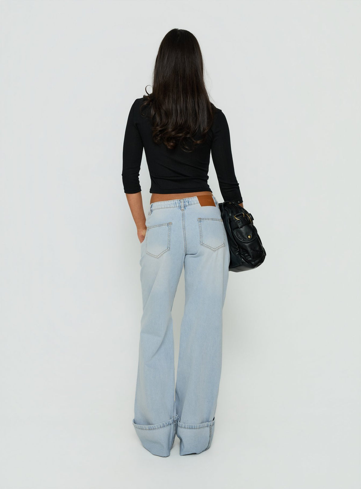 Explore Ezia Wide Cuff Baggy Jeans Light Blue Wash in womens-jeans with high-rise back view of model wearing Princess Polly